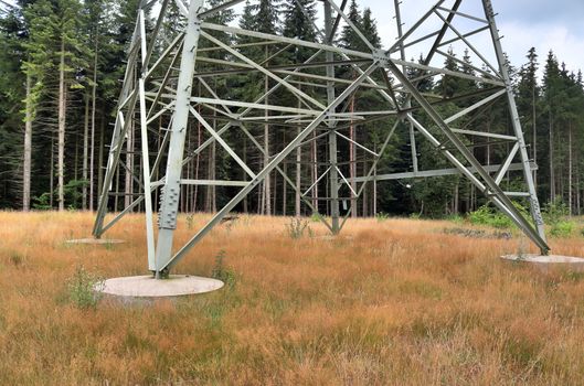 Close up view on a big power pylon transporting electricity in a countryside area in Europe