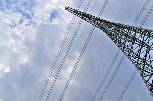 Close up view on a big power pylon transporting electricity in a countryside area in Europe