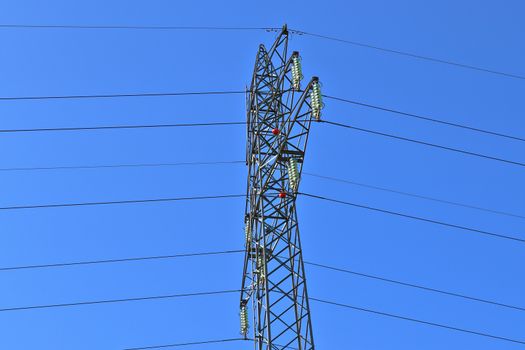 Close up view on a big power pylon transporting electricity in a countryside area in Europe