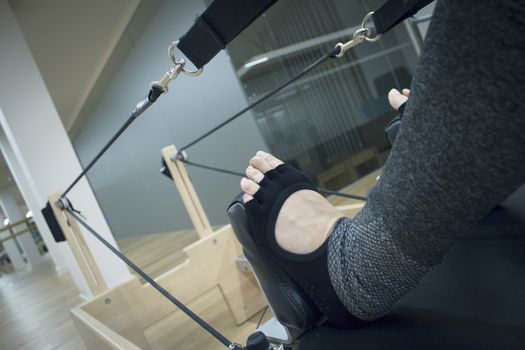 Woman doing pilates machine exercises