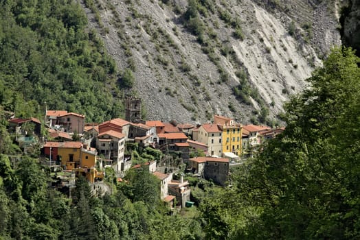 Colonnata, Carrara, Tuscany, Italy. View of the village of Colonnata, where the famous lard is produced. On the right a cascade of marble debris. Northern Tuscany near Carrara.