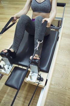 Woman doing pilates machine exercises