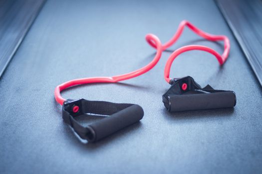 Elastic band for arm exercises on the floor. No people
