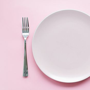 Empty plate and cutlery as mockup set on pink background, top tableware for chef table decor and menu branding design