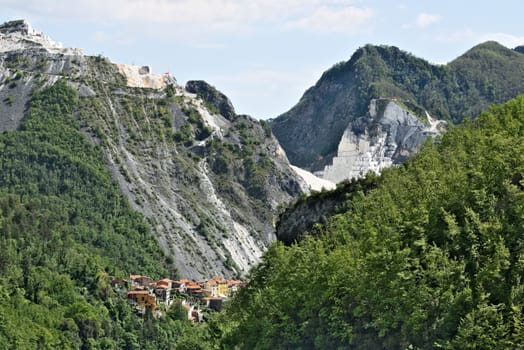 Colonnata, Carrara, Tuscany, Italy. View of the village of Colonnata, where the famous lard is produced. On the right a cascade of marble debris. Northern Tuscany near Carrara.