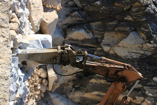 Demolition hammer in a quarry of white Carrara marble.