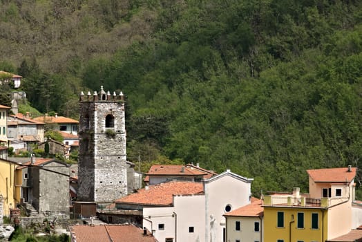 Colonnata, Carrara, Tuscany, Italy.  Overview of the village of Colonnata, where the famous lard is produced. The walls of the houses in stone and white Carrara marble. Woods background. Northern Tuscany.