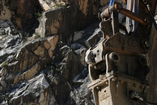 Demolition hammer in a quarry of white Carrara marble.