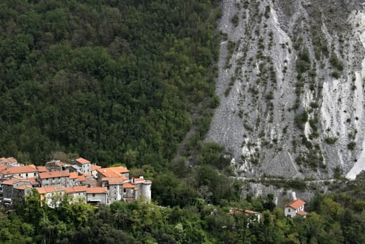 Colonnata, Carrara, Tuscany, Italy. View of the village of Colonnata, where the famous lard is produced. On the right a cascade of marble debris. Northern Tuscany near Carrara.