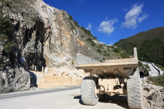 Carrara, Italy. 05/31/2019. A dumper truck used in a Carrara marble quarry. Large yellow dump truck with body.