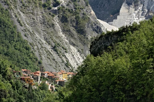 Colonnata, Carrara, Tuscany, Italy. View of the village of Colonnata, where the famous lard is produced. On the right a cascade of marble debris. Northern Tuscany near Carrara.