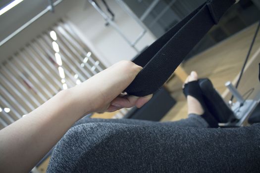 Woman doing pilates machine exercises