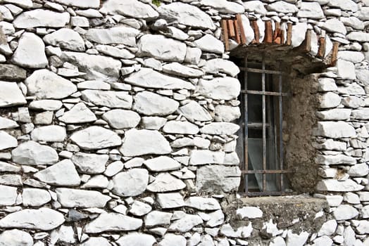 Colonnata, Carrara, Tuscany, Italy. Detail of windows and walls made of white marble extracted from the nearby quarries. Colonnata is famous for the production of tasty lard.