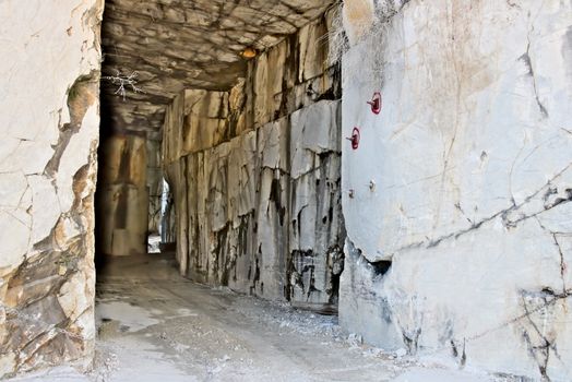 White Carrara marble quarry made in the gallery. The use of diamond tools allows to dig the marble blocks in underground galleries.