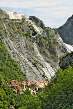Colonnata, Carrara, Tuscany, Italy. View of the village of Colonnata, where the famous lard is produced. On the right a cascade of marble debris. Northern Tuscany near Carrara.