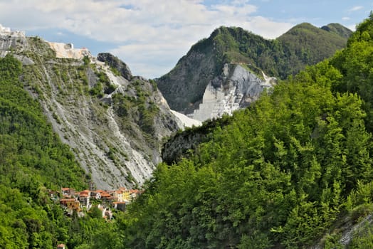 Colonnata, Carrara, Tuscany, Italy. View of the village of Colonnata, where the famous lard is produced. On the right a cascade of marble debris. Northern Tuscany near Carrara.