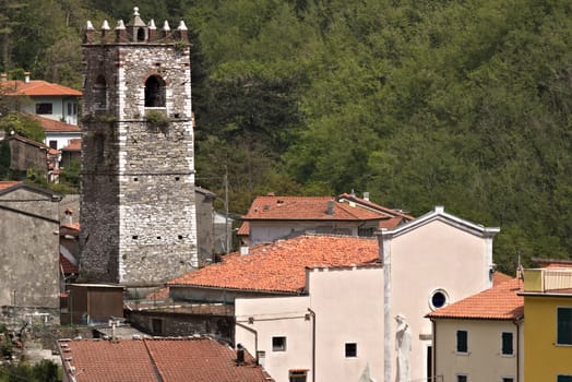 Colonnata, Carrara, Italy. 05/16/2019.  Overview of the village of Colonnata, where the famous lard is produced. The walls of the houses in stone and white Carrara marble. Woods background. Northern Tuscany.