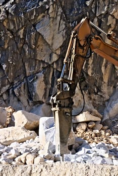 Demolition hammer in a quarry of white Carrara marble.