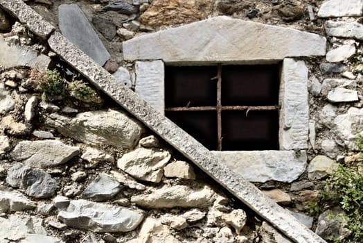 Colonnata, Carrara, Tuscany, Italy. Detail of windows and walls made of white marble extracted from the nearby quarries. Colonnata is famous for the production of tasty lard.