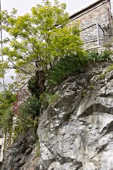 Colonnata, Carrara, Tuscany, Italy.  05/16/2019. A typical village house built over the white marble rock. A view of a country road perched on the Apuan Alps mountains. Tuscany.