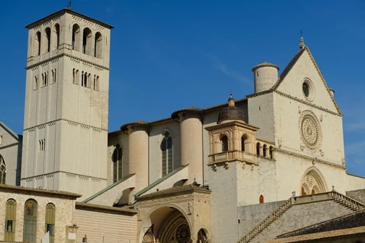 Assisi, Umbria, Italy. About october 2019. Church of San Francesco in Assisi with the stone wall. The basilica built in Gothic style houses the frescoes by Giotto and Cimabue.