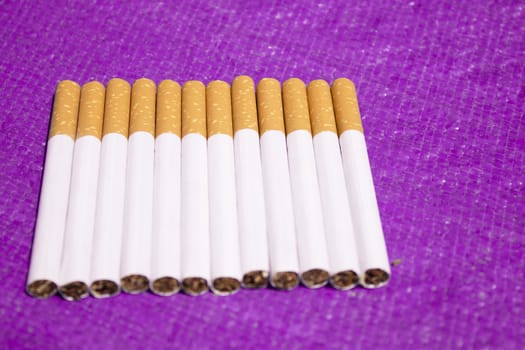 Row of cigarettes on table. No people