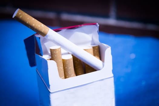 Open cigarette pack with cigarettes out. No people