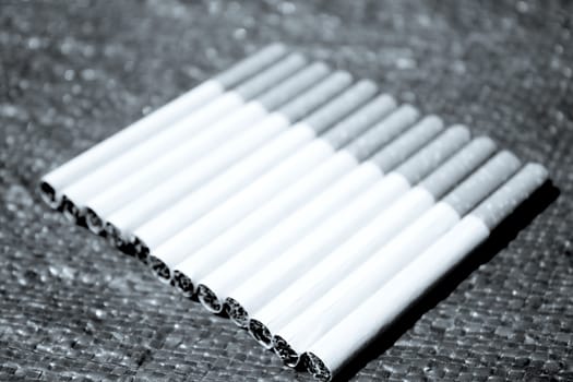 Row of cigarettes on table. No people