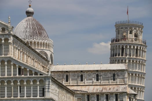 Pisa, Tuscany, Italy. 06/21/2019. Piazza dei miracoli of Pisa. Cathedral, leaning tower of the Tuscan city. Blue sky with clouds.