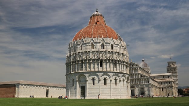 Pisa, Tuscany, Italy. 06/21/2019. Piazza dei miracoli of Pisa. Cathedral, tower and baptistery of the Tuscan city. Blue sky with clouds.