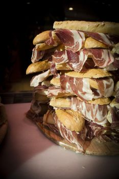 Serrano ham sandwiches stacked. No people