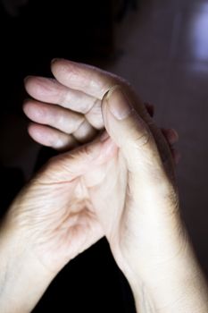 Hands of elderly woman doing a selfmassage. Manual physiotherapy 