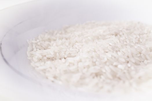 Uncooked white rice. Part of the rice out of focus. No people