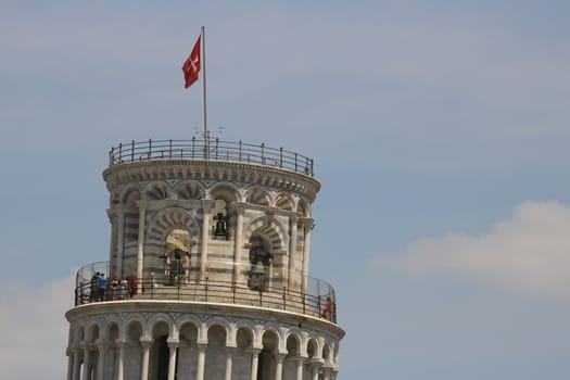 Pisa, Tuscany, Italy. 06/21/2019. Leaning tower of Pisa. Cell with bells. The tower is built entirely with white Carrara marble. On the top floor, visiting tourists.