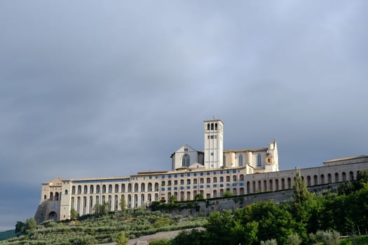 Convent and church of San Francesco in Assisi. The architecture immersed in the countryside with cultivation of olive trees.