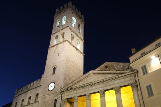 Assisi, Umbria. Town square of Assisi with the tower and the temple of Minerva. The city of San Francesco with the lights of the night.