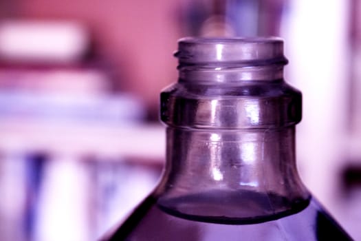 Glass transparent water bottle on blur background. No people