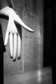 Artificial hand showing palm of hand on dark background. No people