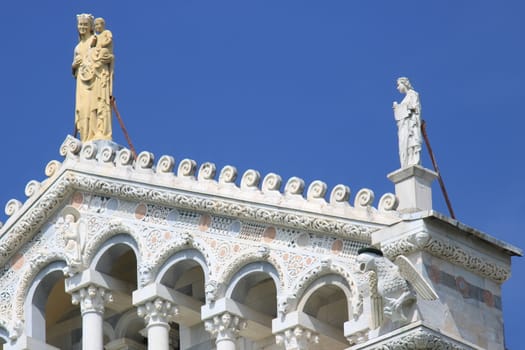 Pisa, Tuscany, Italy. 06/21/2019. Detail of the facade of the Duomo of Pisa with sculptures. The cathedral is built in white marble.