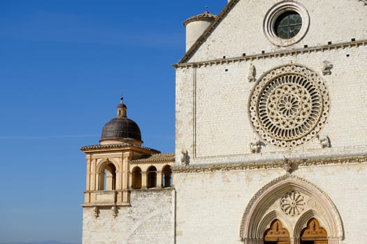 Assisi, Umbria, Italy. About october 2019. Church of San Francesco in Assisi with the stone wall. The basilica built in Gothic style houses the frescoes by Giotto and Cimabue.