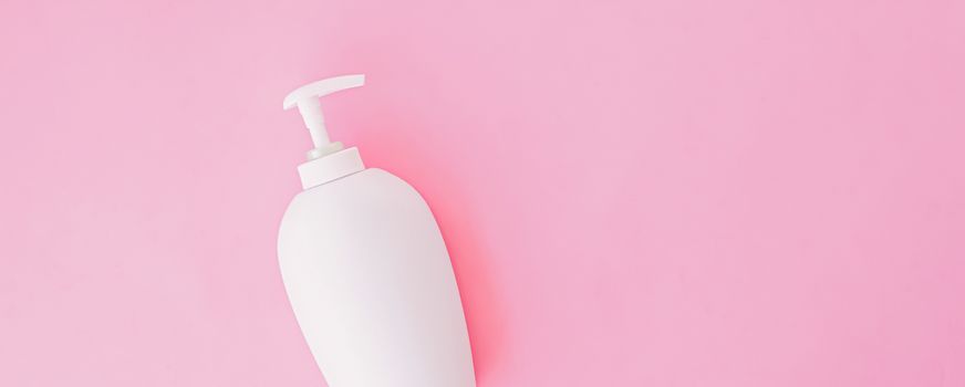 Bottle of antibacterial liquid soap and hand sanitizer on pink background, hygiene product and healthcare, flatlay