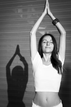 Girl dressed in white with yoga poses, very spiritual. Pink backgroun