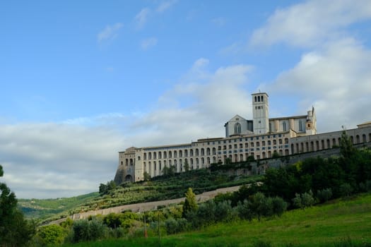 Convent and church of San Francesco in Assisi. The architecture immersed in the countryside with cultivation of olive trees.