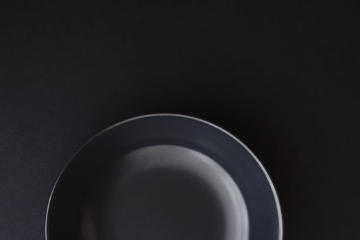 Empty plates on black background, premium dishware for holiday dinner, minimalistic design and diet concept