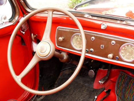 Old car painted in bright red with chrome details