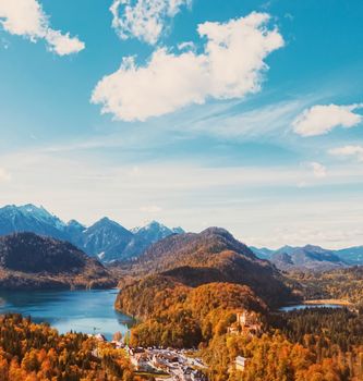Beautiful nature of European Alps, landscape view of alpine mountains, lake and village in autumn season, travel and destination scenery