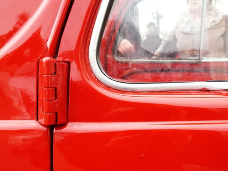 Old car painted in bright red with chrome details