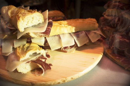 Serrano ham and cheese sandwiches stacked. No people