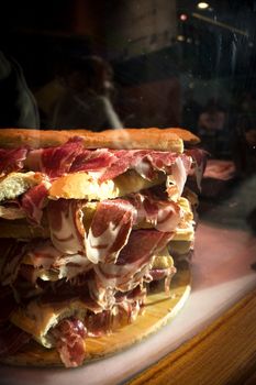 Serrano ham sandwiches stacked. No people