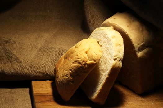 Sliced loaf of white bread on canvas background